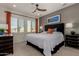 Cozy bedroom with a comfortable bed, neutral carpet and an artful accent wall at 4548 S Renaissance Dr # 103, Gilbert, AZ 85297
