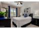 Stylishly decorated bedroom with a queen-sized bed, shiplap accent wall, and modern furnishings at 4548 S Renaissance Dr # 103, Gilbert, AZ 85297