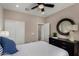 Cozy bedroom showcasing a full-sized bed, round mirror, and dark dresser against neutral walls at 4548 S Renaissance Dr # 103, Gilbert, AZ 85297