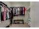 Spacious walk-in closet with ample storage, clothing racks, and a woven bench for comfortable organization at 4548 S Renaissance Dr # 103, Gilbert, AZ 85297