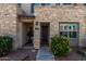 Inviting townhome entrance with a stone facade, well-maintained landscaping, and a clearly marked unit number at 4548 S Renaissance Dr # 103, Gilbert, AZ 85297