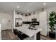 Modern kitchen with stainless steel appliances, white cabinetry, and a functional island with bar seating at 4548 S Renaissance Dr # 103, Gilbert, AZ 85297