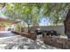 Covered patio area with a built-in grill and lush landscaping at 4822 N 63Rd Ln, Phoenix, AZ 85033