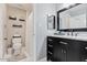 Clean bathroom featuring a marble vanity top, black fixtures, and a tiled floor at 4822 N 63Rd Ln, Phoenix, AZ 85033