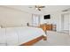 Bright bedroom featuring plush carpeting, a ceiling fan, and a TV mounted on the wall at 4822 N 63Rd Ln, Phoenix, AZ 85033