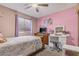Pink bedroom with a ceiling fan, gray carpet, and a vanity set at 4822 N 63Rd Ln, Phoenix, AZ 85033