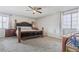 This is a bedroom with carpet and a large bed and a window with curtains at 4822 N 63Rd Ln, Phoenix, AZ 85033