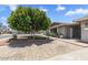 Single-story home with mature tree and neatly landscaped front yard at 4822 N 63Rd Ln, Phoenix, AZ 85033