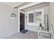 Inviting front porch with welcome decor, decorative seating, and beautiful window at 4822 N 63Rd Ln, Phoenix, AZ 85033