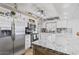 Charming kitchen with granite counters, stainless appliances, and white cabinetry at 4822 N 63Rd Ln, Phoenix, AZ 85033