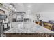 Bright kitchen featuring a large island with seating and stylish granite countertops at 4822 N 63Rd Ln, Phoenix, AZ 85033
