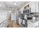 Well-equipped kitchen with stainless steel appliances, and long granite countertops at 4822 N 63Rd Ln, Phoenix, AZ 85033