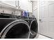 Well-lit laundry room features new appliances and white cabinetry at 4822 N 63Rd Ln, Phoenix, AZ 85033