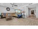 Inviting living room featuring hardwood floors, a ceiling fan, and a comfortable sofa at 4822 N 63Rd Ln, Phoenix, AZ 85033