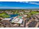 Aerial view of the neighborhood featuring a golf course, lake, clubhouse, and pool at 515 S Saguaro Way, Mesa, AZ 85208