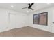 Bedroom with wood-look floors, a ceiling fan, a window, and a closet with sliding doors at 515 S Saguaro Way, Mesa, AZ 85208