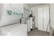 Functional laundry room equipped with a stacked washer/dryer, storage shelves, and a water heater at 515 S Saguaro Way, Mesa, AZ 85208