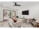 Bright living room with modern decor, ceiling fan, and sliding glass doors at 515 S Saguaro Way, Mesa, AZ 85208