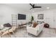 Well-lit living room featuring a ceiling fan, ample seating, and neutral decor at 515 S Saguaro Way, Mesa, AZ 85208
