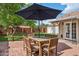Cozy backyard patio with dining furniture, shade umbrella, and view of the lush lawn at 522 W Cambridge Ave, Phoenix, AZ 85003