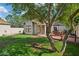 Spacious backyard with lush lawn, brick patio, and mature trees surrounding the property at 522 W Cambridge Ave, Phoenix, AZ 85003