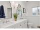 Bright bathroom with double sinks, decorative mirrors, and a window, providing natural light at 522 W Cambridge Ave, Phoenix, AZ 85003