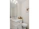 Modern bathroom with a marble vanity, decorative mirror, and shower at 522 W Cambridge Ave, Phoenix, AZ 85003