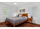 Comfortable bedroom with wood floors, ceiling fan, and windows letting in natural light at 522 W Cambridge Ave, Phoenix, AZ 85003