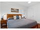 Bright bedroom with hardwood floors, a ceiling fan, and a picture window at 522 W Cambridge Ave, Phoenix, AZ 85003