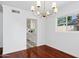 Open dining room showcasing a stylish chandelier and views into the updated kitchen at 522 W Cambridge Ave, Phoenix, AZ 85003
