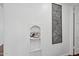 Quirky hallway decor features an antique phone nook and a piece of abstract wall art at 522 W Cambridge Ave, Phoenix, AZ 85003