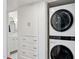 Laundry area has stacked washer/dryer and built-in storage adjacent to a tiled bathroom at 522 W Cambridge Ave, Phoenix, AZ 85003