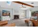 Spacious living room featuring a brick fireplace, leather couches, a skylight, and wooden beams at 522 W Cambridge Ave, Phoenix, AZ 85003