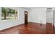 Spacious living room featuring hardwood flooring and a large window at 522 W Cambridge Ave, Phoenix, AZ 85003