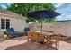 Charming outdoor patio with brick pavers, ample seating, and a large shade umbrella at 522 W Cambridge Ave, Phoenix, AZ 85003