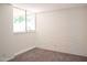 Bright bedroom with a painted brick wall and large window offering natural light and neighborhood views at 5246 N 20Th St # B1, Phoenix, AZ 85016