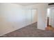 Cozy bedroom featuring neutral carpet, mirrored closet doors, and an open ensuite bathroom at 5246 N 20Th St # B1, Phoenix, AZ 85016