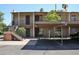 Apartment complex with covered parking, outdoor staircases, brick supports, and mature landscaping at 5246 N 20Th St # B1, Phoenix, AZ 85016