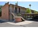 Apartment complex with covered parking, outdoor staircases, brick supports and manicured landscaping at 5246 N 20Th St # B1, Phoenix, AZ 85016