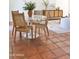 Bright dining room featuring Saltillo tile flooring, a white marble tulip table, and woven back chairs at 5246 N 20Th St # B1, Phoenix, AZ 85016