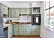 Charming kitchen with sage-green cabinets, butcher block countertops, stainless steel appliances and terracotta floor at 5246 N 20Th St # B1, Phoenix, AZ 85016