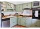 Charming kitchen with sage-green cabinets, butcher block countertops, stainless steel appliances and a rustic terracotta floor at 5246 N 20Th St # B1, Phoenix, AZ 85016