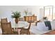 Open-concept living room showcasing dining table with terracotta floors, modern furniture and sunlit interiors at 5246 N 20Th St # B1, Phoenix, AZ 85016