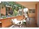 Charming covered patio with brick surround, outdoor seating, and views of the community at 5246 N 20Th St # B1, Phoenix, AZ 85016