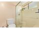 Bathroom showing glass shower, toilet, and built-in bench at 6422 N 77Th Way, Scottsdale, AZ 85250