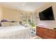 Bright bedroom with large window and a ceiling fan at 6422 N 77Th Way, Scottsdale, AZ 85250