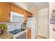 Kitchen features stainless steel appliances, granite counters and light wood cabinetry at 6422 N 77Th Way, Scottsdale, AZ 85250