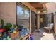 Outdoor patio with sliding glass doors, cozy seating, and vibrant plants, creating a relaxing space at 6422 N 77Th Way, Scottsdale, AZ 85250