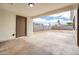 Covered patio area with concrete floor, backyard access, and block wall at 6627 S 42Nd Pl, Phoenix, AZ 85042