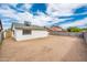 Large, dirt backyard enclosed by tall block fencing offering privacy at 6627 S 42Nd Pl, Phoenix, AZ 85042